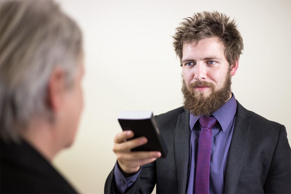 Man swearing oath on a Bible.